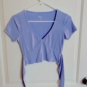Only worn once! Light blue soft ribbed top with a tie detail/cutout in the back